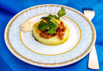 Zucchini baked in the oven with minced meat and cheese, decorated with green parsley.