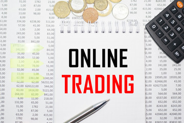 Online Trading on the block on the background of financial reporting, coins, calculator, pens and yellow stickers. Business concept