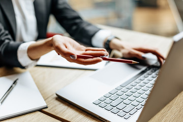 Woman at the workplace in the office near the notepad. Business concept. Businesswoman works at a laptop. Business hours.