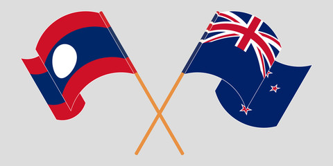 Crossed and waving flags of Laos and New Zealand