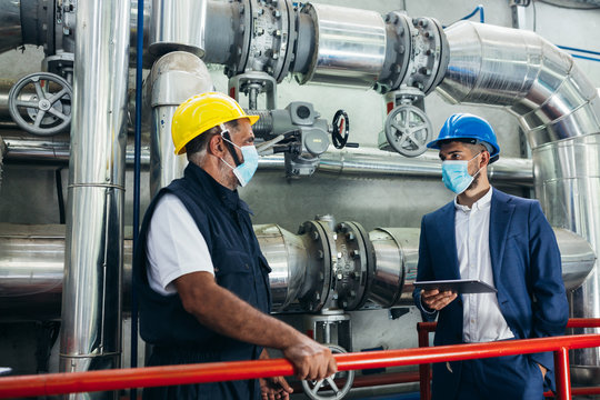 Middle Aged Industry Worker And Businessman Working Indoor In Heating Plant