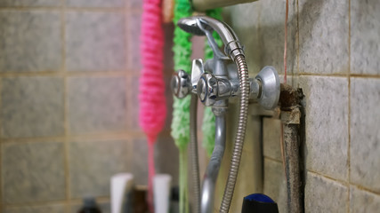 colourful sponges and washcloths hang on wall behind shower