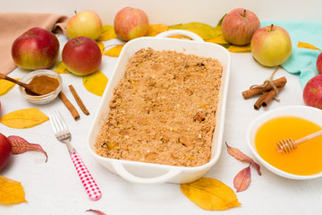 Apple crisp crumble for home cooking on a light background top view. traditional autumn dessert with cinnamon and oatmeal, honey.