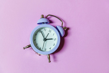 Simply minimal design ringing twin bell vintage classic alarm clock Isolated on purple violet...