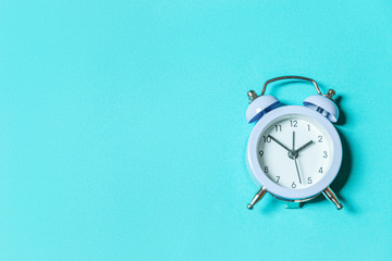 Simply minimal design ringing twin bell vintage classic alarm clock Isolated on blue pastel...