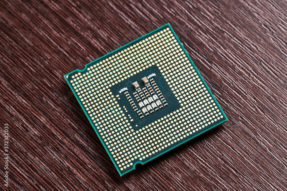 Aufkleber cpu processor hardware unit over wooden background. computer chip close up. digital industry concept