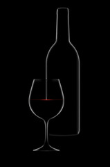 A dramatic rim light outlines a bottle and glass of red wine with light sparkling on the surface of the wine.
