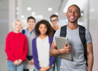 Smiling young college student with laptop