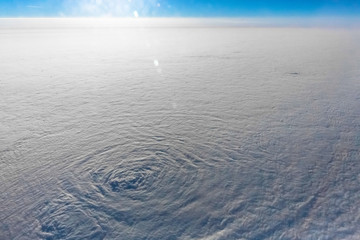 Clouds from the airplane window. Snowy white fluffy clouds. 10,000 m above the ground.