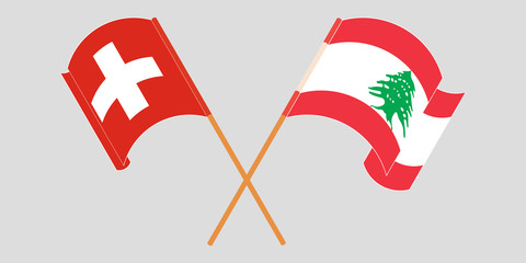 Crossed and waving flags of Lebanon and Switzerland