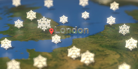 London city and snowy weather icon on the map, weather forecast related 3D rendering
