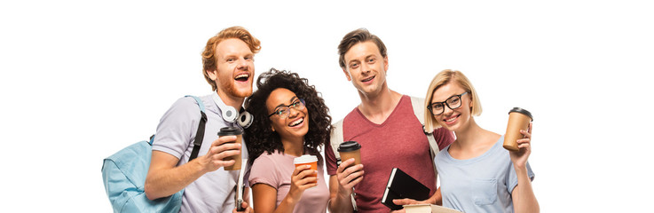 Panoramic shot of multicultural students with coffee to go looking at camera isolated on white