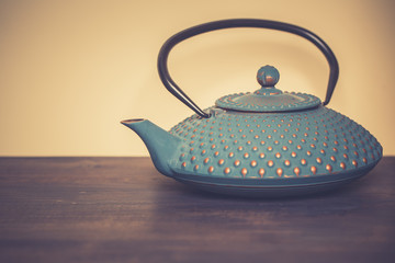Traditional japanese herbal tea recipe prepared in cast iron teapot with organic dry herbs. Alternative medicine. Healthy asian green tea in tea pot on vintage wooden table background.