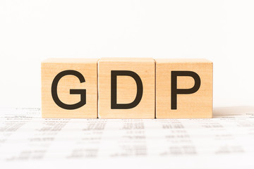 Word GDP. Wooden small cubes with letters isolated on white background with copy space available
