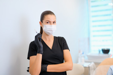 Beautician with injection in syringe