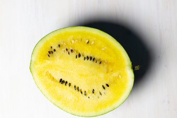 yellow watermelon on a white wooden background