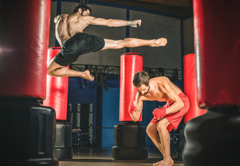 Kickboxer kick in the air against the opponent.