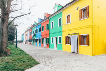 Fototapeta na wymiar Island of Burano, Venice, Italy. Colored houses. Postcard from Burano on foggy day.