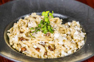 Gnocchi with cottage cheese and roasted bacon on plates. The food in the restaurant. Food styling and restaurant meal serving.