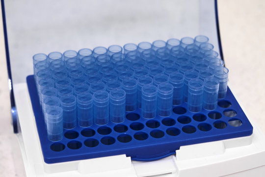 Blue one millilitre pipette tips in the box. Chemical laboratory. 