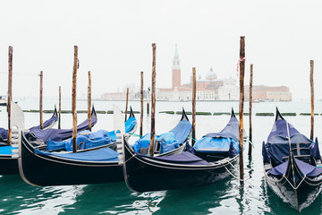 Fototapeta na wymiar Gondolas moored by Piazza San Marco with the church of San Giorgio di Maggiore in Venice, Italy.