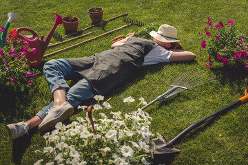 Gardening  Gardener Girl Relaxed Lying  Green Grass, Surrounded Gardening Tools With Plants...