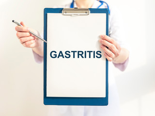 Doctor keeps a paper with the diagnosis - gastritis. Medical concept.