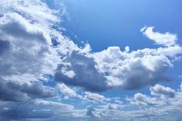 Bright blue of the sky with beautiful cumulus clouds illuminated by the sun at its zenith