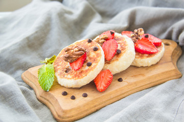 A healthy breakfast of pancakes, strawberries, chocolate, and honey