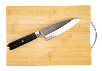 A kitchen knife on a wooden cutting board, isolated on white background