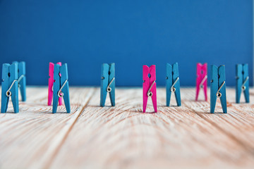 colorful wooden clothespin - abstract vision of man and woman. standing out from the crowd,...