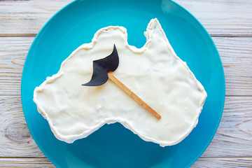 vanilla cream cake in a shape of the Australia  message greeting card, with mustache, father's day gift