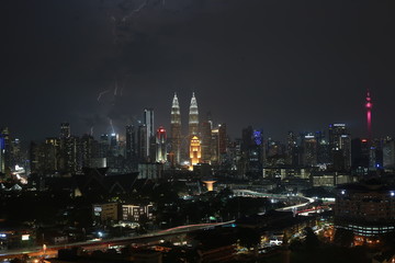 Fototapeta na wymiar Thunderstorm lightning strike and heavy raining in Kuala Lumpur city