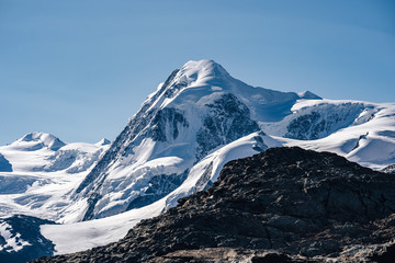 The summit of Liskamm (Lyskamm), famous alpine peak above Zermatt, Switzerland. Moutain alpine landscape of Wallis. Snow and ice covered peak, Monte Rosa Glacier.