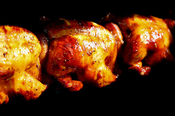 Grilled chicken on the flaming grill