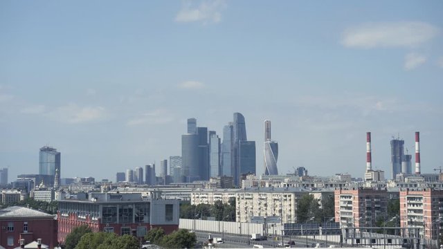 Panoramic view of city and blue skyscrapers. Action. Simple view of city on background of high-rise buildings in Moscow city. Skyscrapers of Moscow city on horizon on background blue sky
