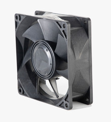 DC brushless fan with 5 volt and 12 volt DC. Mini cooling fan made of black plastic complete with cables on isolated white background.