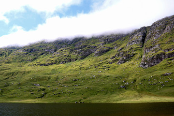 Fototapeta na wymiar Small Scottish Loch and Mountainside at Dusk