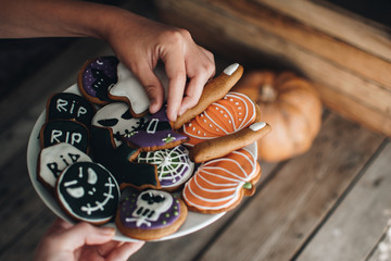 Happy Halloween! Child is taking sweets. Close up. Halloween cookies. Holiday concept. Pumpkin. Autumn mood. 