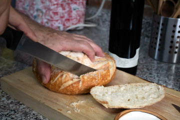 Hand cutting bread