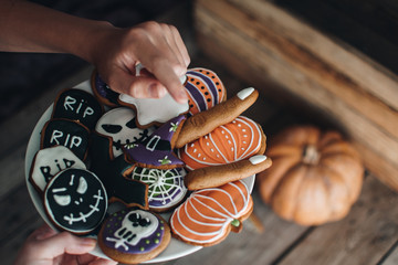 Happy Halloween! Child is taking sweets. Close up. Halloween cookies. Holiday concept. Pumpkin. Autumn mood. 