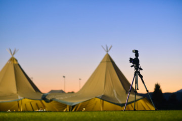 Tent with teepees at night with tripod and camera. © Cubodeluz