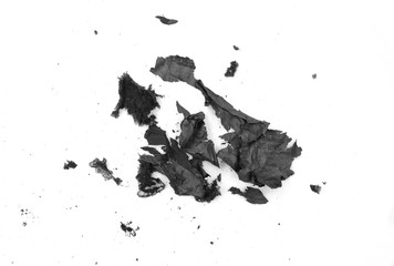 Obraz premium Burnt paper on a white background. The ashes of the paper. Charred paper scraps.