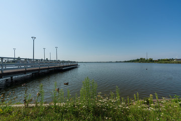 Pier on a small lake in the town of Znin on a sunny summer day