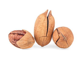 Pecan nuts isolated on a white background. Whole and cracked pecan nuts.