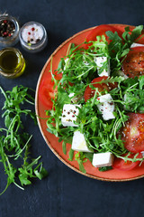 Fresh salad with arugula, white cheese and tomato.
healthy salad. Vegetarian diet.