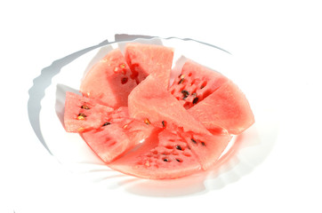 Ripe watermelon pieces on the plate isolated on white, delicious berry