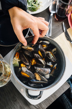 Tourists eating typical mussels in Bruges, Belgium
