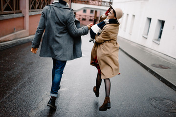 couple holding hands and run together on the road