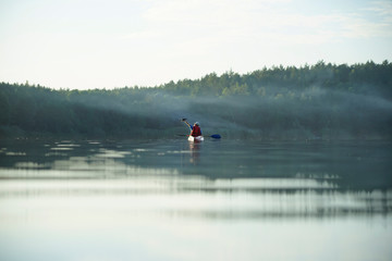 Fototapeta premium guy launches drone from boat over water